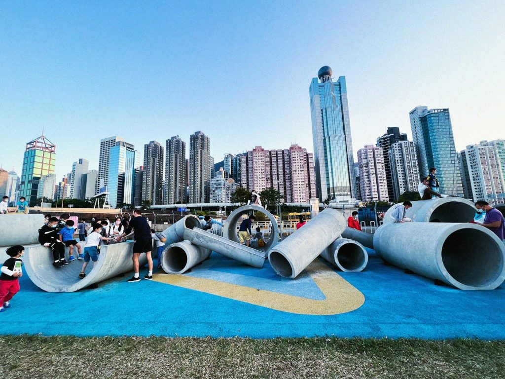 a group of people sitting on top of cement pipes