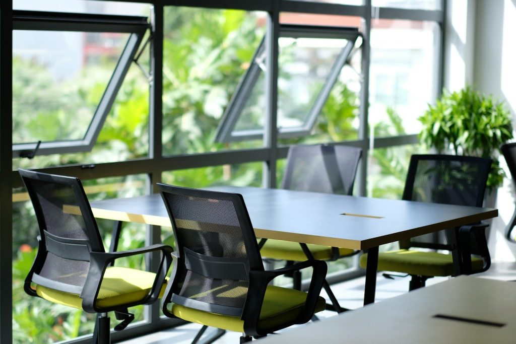 empty black and green armchairs beside table