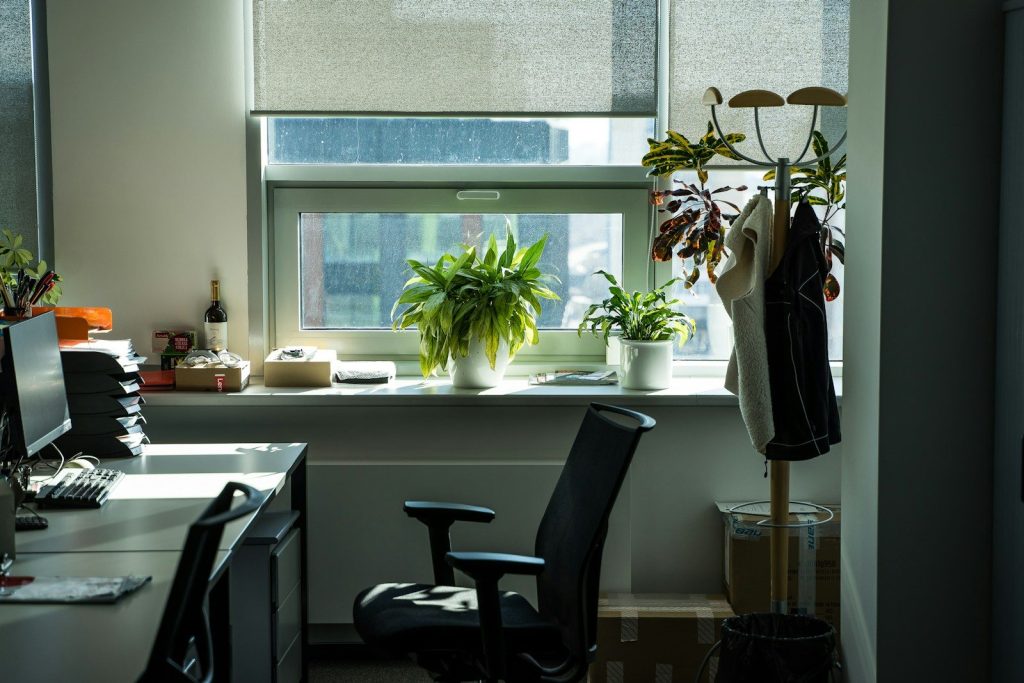 black office rolling chair beside white wooden desk
